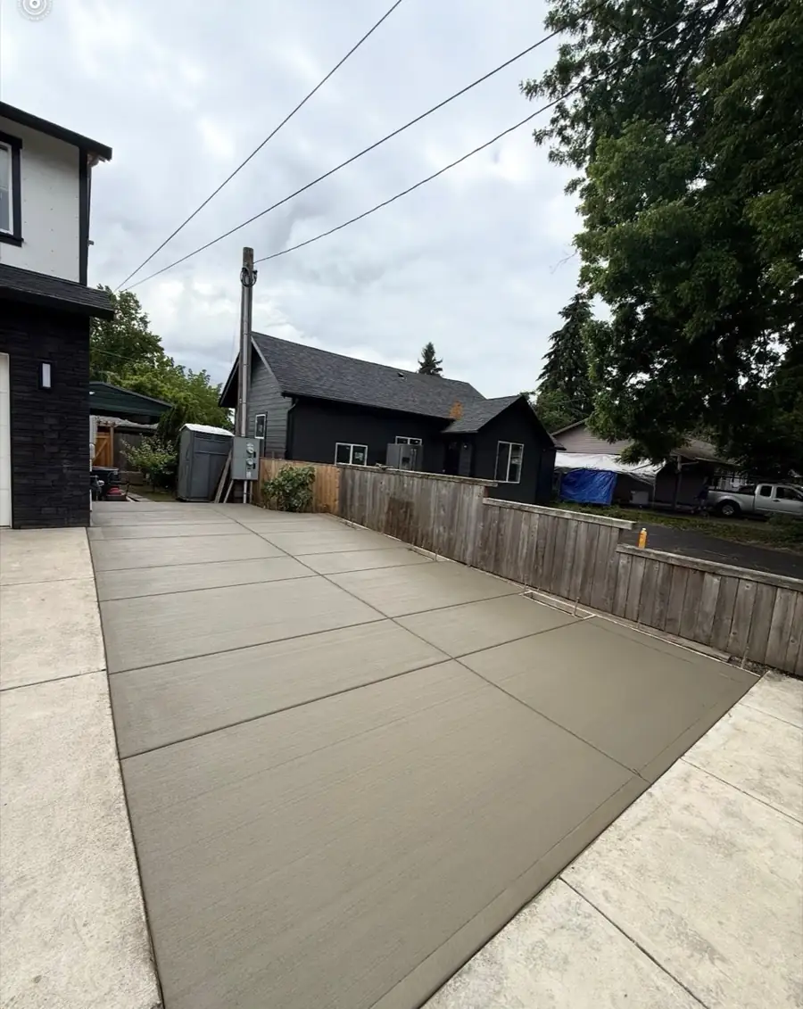 Long concrete driveway alongside a rural home