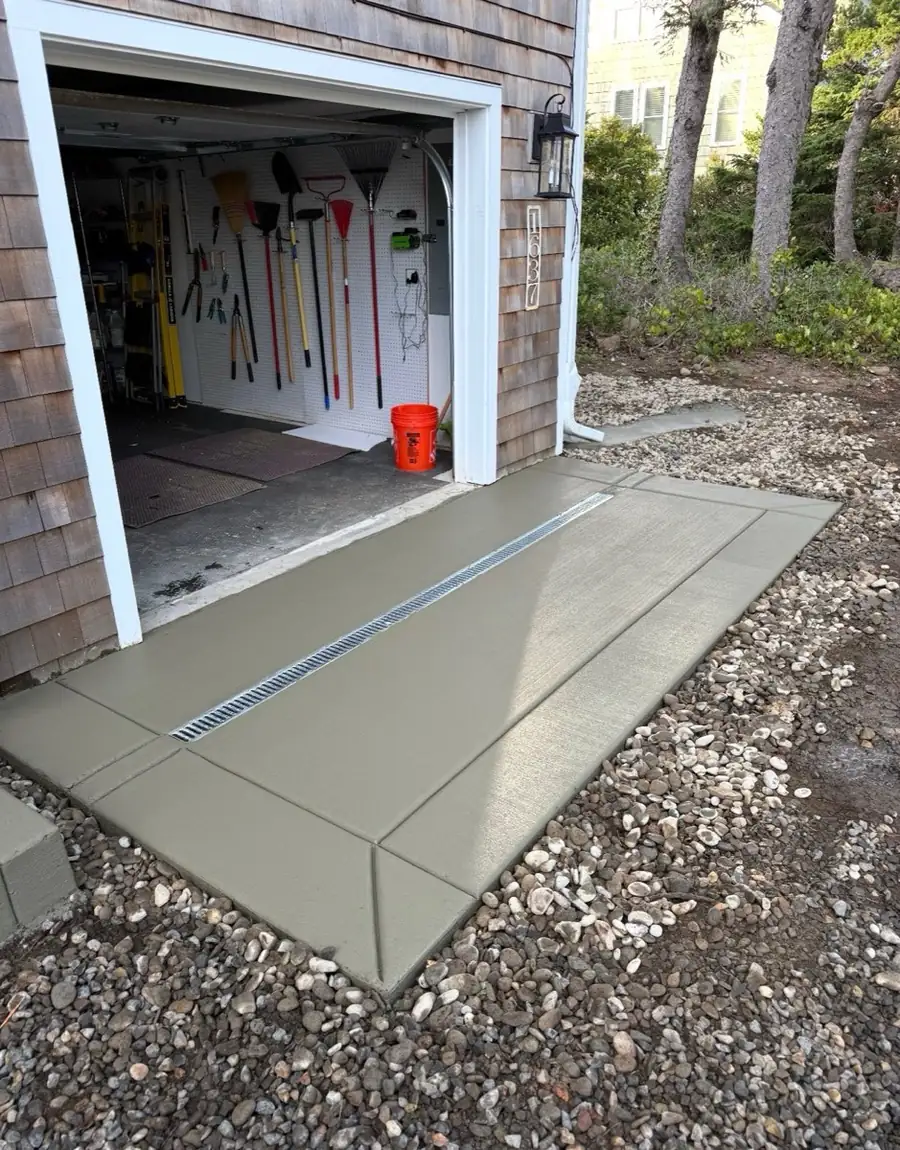 Concrete walkway beside a house with a clean broom finish